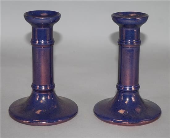 A pair of Moorcroft purple lustre candlesticks, 6in.